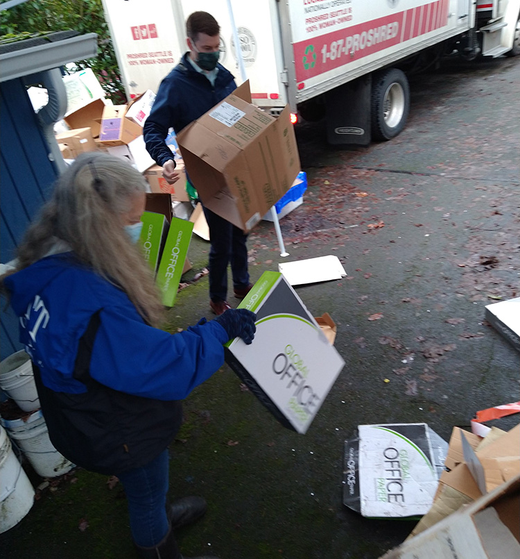 Clean up after the pile of shredding at the free shred event.